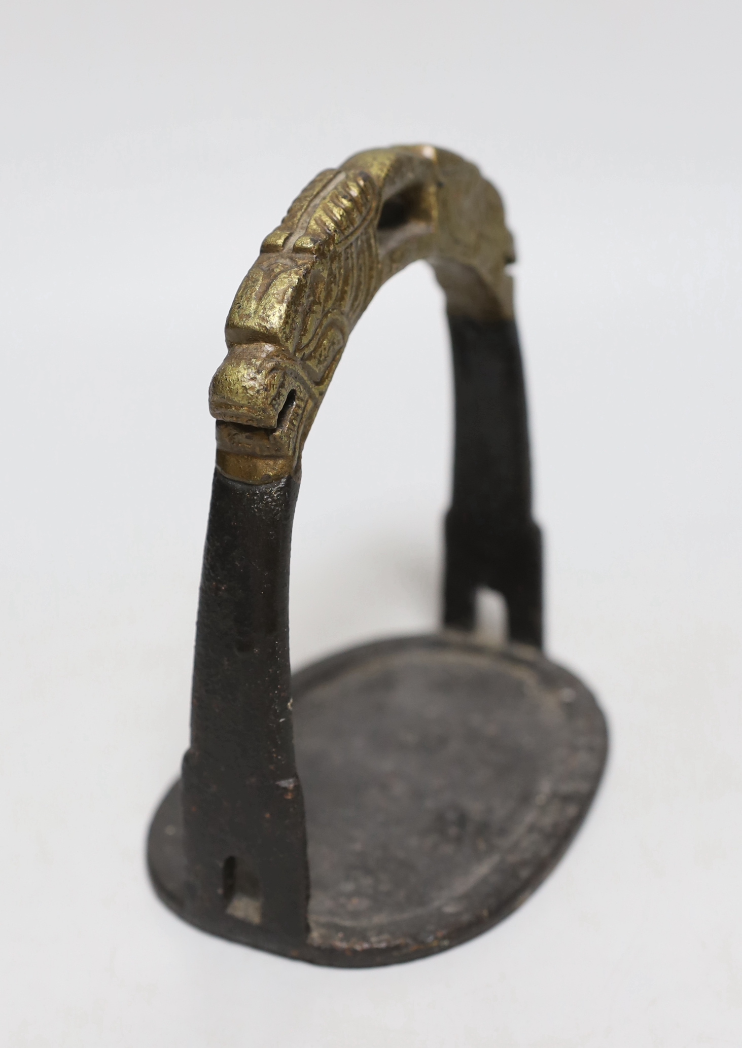 A Chinese cast iron stirrup, with dragon decoration, 16cm high